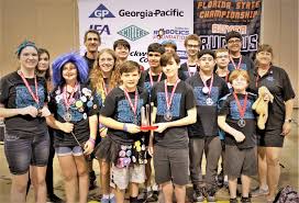 Students loading robot into transport case